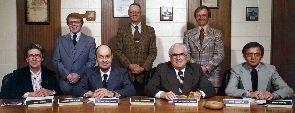 Seven counillors sitting around a council table
